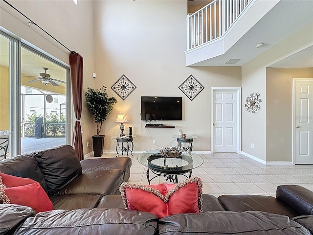 219 Rosso Dr, Davenport, FL 33837 - living room featuring a towering ceiling, baseboards, tile patterned floors, and a ceiling fan