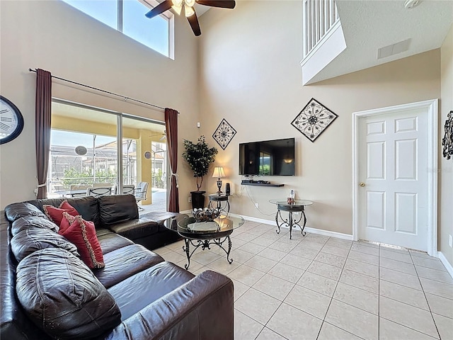 219 Rosso Dr, Davenport, FL 33837 - living area with a ceiling fan, light tile patterned floors, a high ceiling, healthy amount of natural light, and baseboards