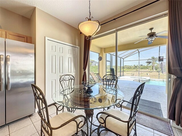 219 Rosso Dr, Davenport, FL 33837 - dining room featuring a sunroom, light tile patterned flooring, and ceiling fan