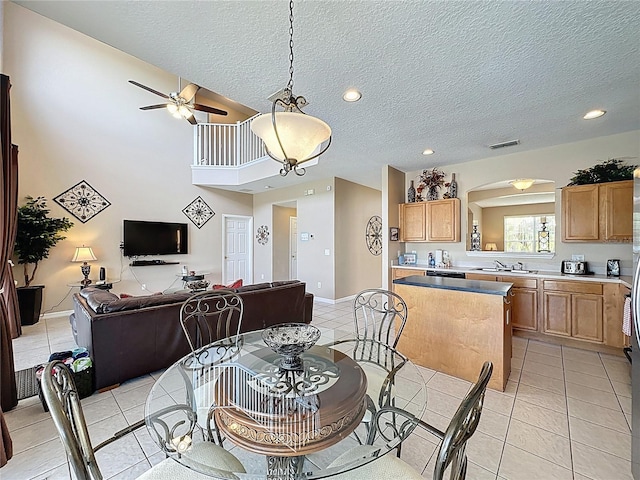 219 Rosso Dr, Davenport, FL 33837 - dining space featuring arched walkways, ceiling fan, light tile patterned flooring, a textured ceiling, and recessed lighting
