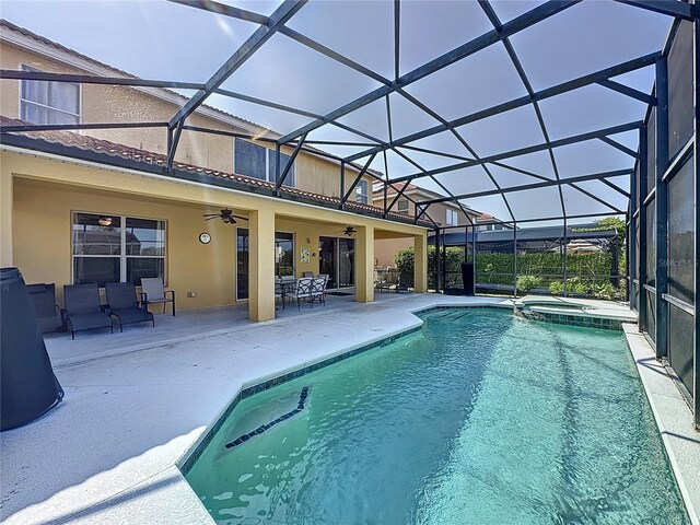 219 Rosso Dr, Davenport, FL 33837 - view of swimming pool with a ceiling fan, a patio, a pool with connected hot tub, and glass enclosure