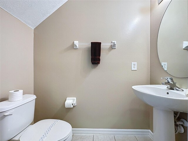 219 Rosso Dr, Davenport, FL 33837 - half bath featuring toilet, baseboards, tile patterned flooring, and a textured ceiling