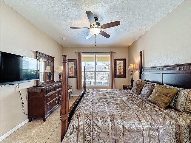 219 Rosso Dr, Davenport, FL 33837 - bedroom featuring a textured ceiling, baseboards, light tile patterned floors, and ceiling fan