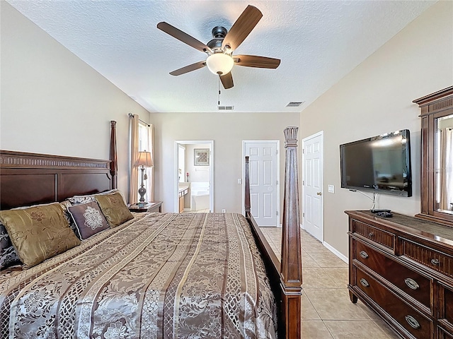 219 Rosso Dr, Davenport, FL 33837 - bedroom featuring a textured ceiling, light tile patterned flooring, connected bathroom, and ceiling fan