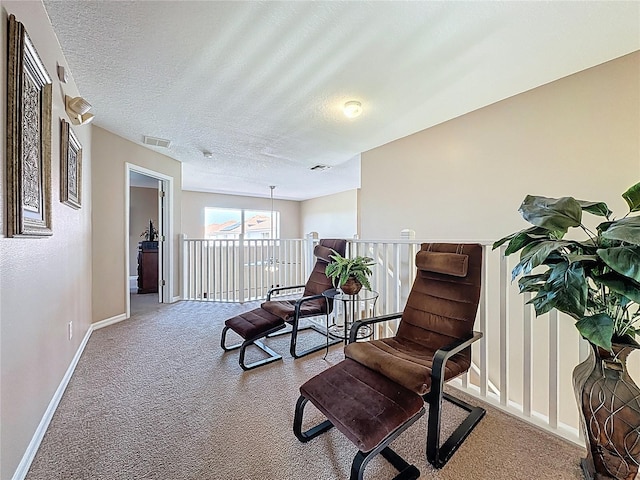 219 Rosso Dr, Davenport, FL 33837 - living area featuring carpet flooring, baseboards, an upstairs landing, and a textured ceiling