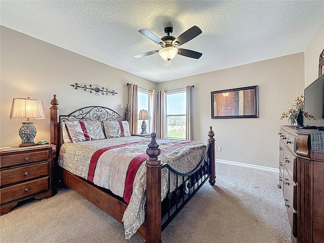 219 Rosso Dr, Davenport, FL 33837 - carpeted bedroom with a textured ceiling, baseboards, and a ceiling fan