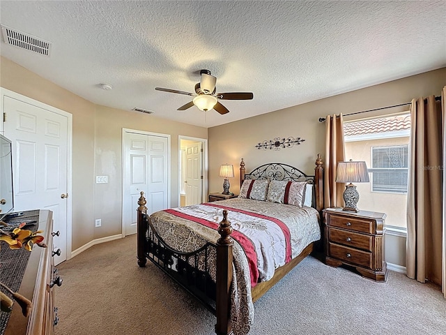 219 Rosso Dr, Davenport, FL 33837 - bedroom featuring light colored carpet, baseboards, a ceiling fan, a closet, and a textured ceiling