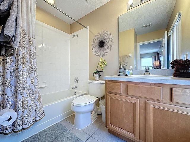 219 Rosso Dr, Davenport, FL 33837 - full bath with toilet, a textured ceiling, vanity, shower / bath combo with shower curtain, and tile patterned floors