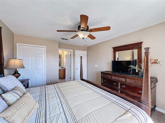 219 Rosso Dr, Davenport, FL 33837 - carpeted bedroom with baseboards, ceiling fan, a closet, a textured ceiling, and connected bathroom