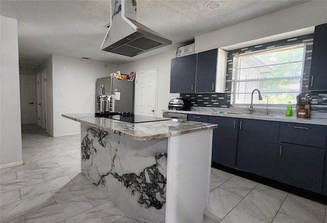 kitchen with light marble finish flooring, a sink, extractor fan, freestanding refrigerator, and a kitchen island