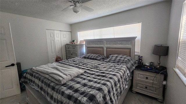 bedroom with a textured ceiling, a closet, and ceiling fan