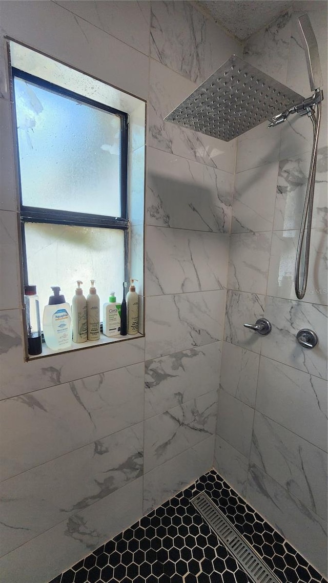 bathroom with a tile shower