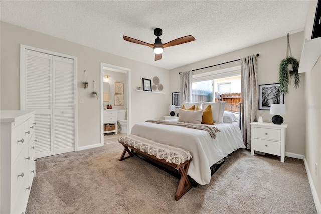 1050 Dees Dr, Oviedo, FL 32765 - bedroom with light carpet, a closet, ensuite bathroom, a textured ceiling, and baseboards