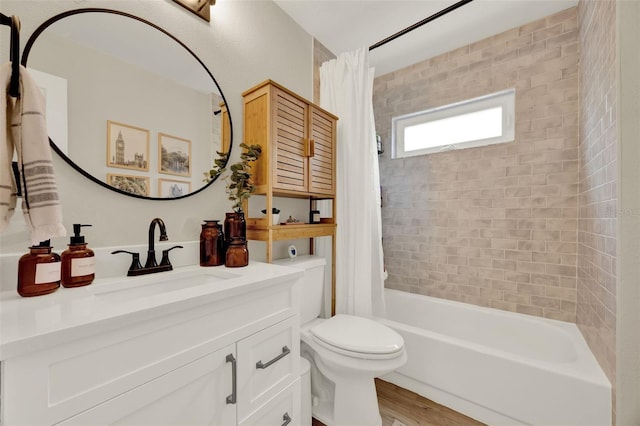 1050 Dees Dr, Oviedo, FL 32765 - full bath featuring shower / bath combo with shower curtain, toilet, vanity, and wood finished floors