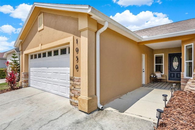 1050 Dees Dr, Oviedo, FL 32765 - entrance to property with stone siding, an attached garage, stucco siding, and concrete driveway