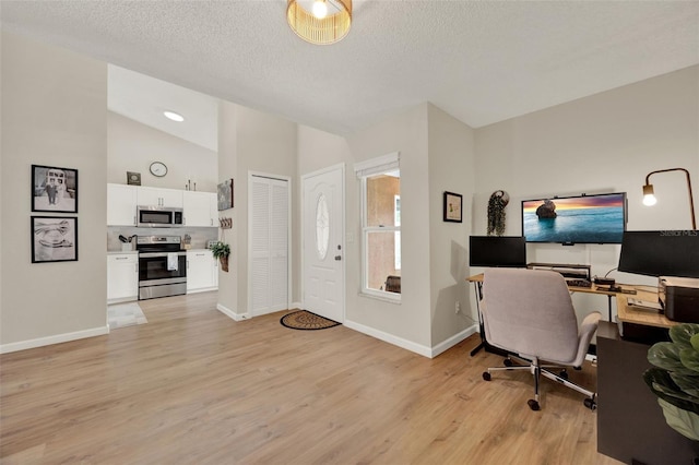 1050 Dees Dr, Oviedo, FL 32765 - office with light wood finished floors, baseboards, vaulted ceiling, and a textured ceiling