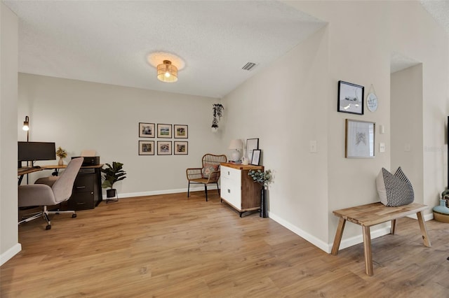 1050 Dees Dr, Oviedo, FL 32765 - office with light wood-style floors, baseboards, and a textured ceiling