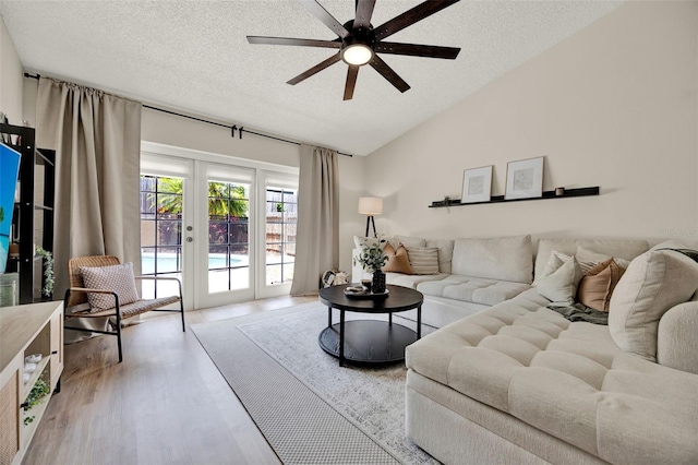 1050 Dees Dr, Oviedo, FL 32765 - living area featuring lofted ceiling, a ceiling fan, a textured ceiling, and wood finished floors