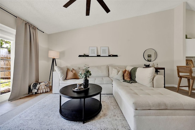 1050 Dees Dr, Oviedo, FL 32765 - living room with a ceiling fan, wood finished floors, and a textured ceiling