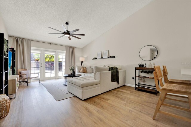 1050 Dees Dr, Oviedo, FL 32765 - living room featuring ceiling fan, light wood finished floors, a textured ceiling, and lofted ceiling