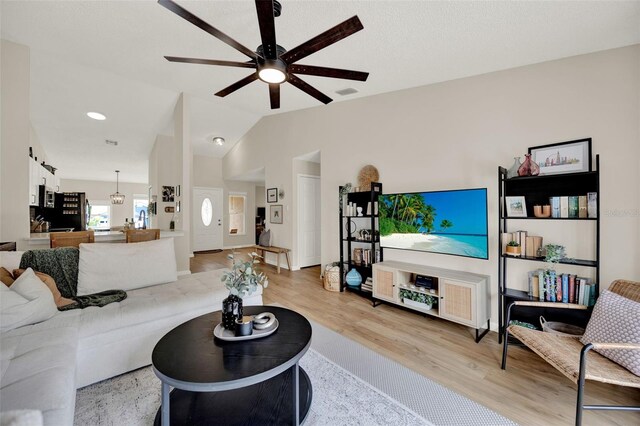 1050 Dees Dr, Oviedo, FL 32765 - living room featuring ceiling fan, light wood-style flooring, and vaulted ceiling