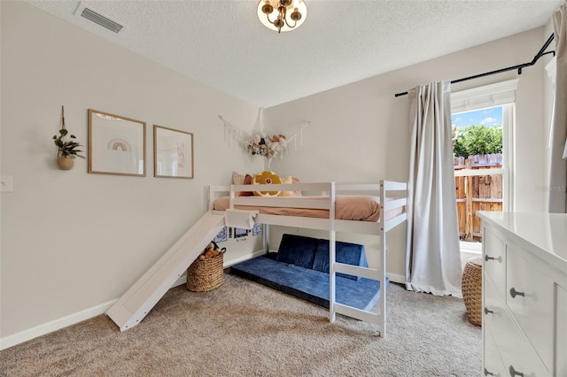 1050 Dees Dr, Oviedo, FL 32765 - bedroom featuring light carpet, a textured ceiling, and baseboards
