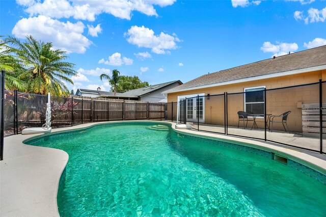 1050 Dees Dr, Oviedo, FL 32765 - view of swimming pool with french doors, a patio area, and a fenced backyard