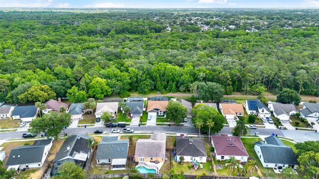 1050 Dees Dr, Oviedo, FL 32765 - aerial overview of property's location with a heavily wooded area and nearby suburban area