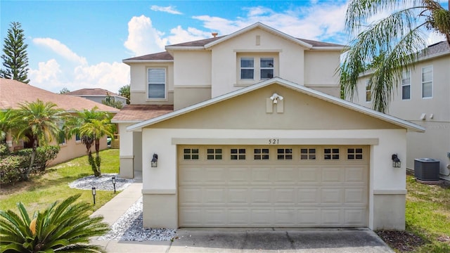 521 Rena Dr, Davenport, FL 33897 - view of front of house with stucco siding, driveway, and central AC unit