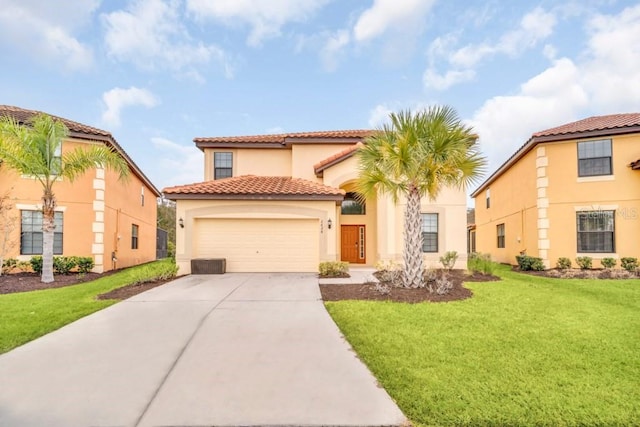 mediterranean / spanish house with a garage, stucco siding, a tile roof, concrete driveway, and a front lawn