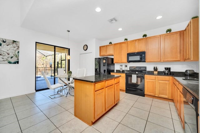kitchen featuring a center island, light tile patterned floors, visible vents, and black appliances