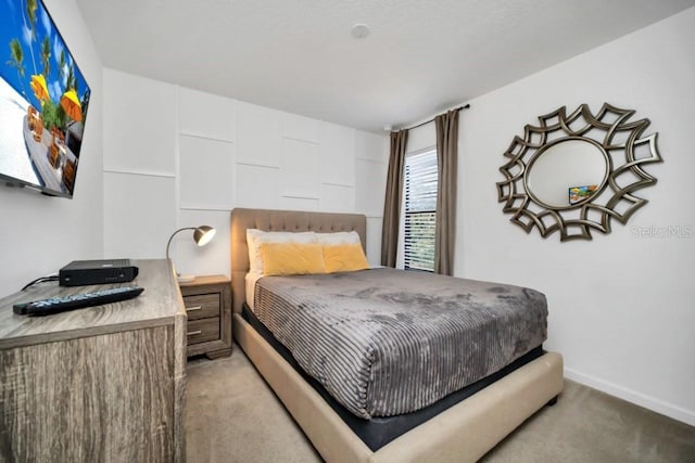 bedroom with baseboards and carpet floors