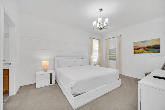 bedroom with light carpet, baseboards, and a notable chandelier