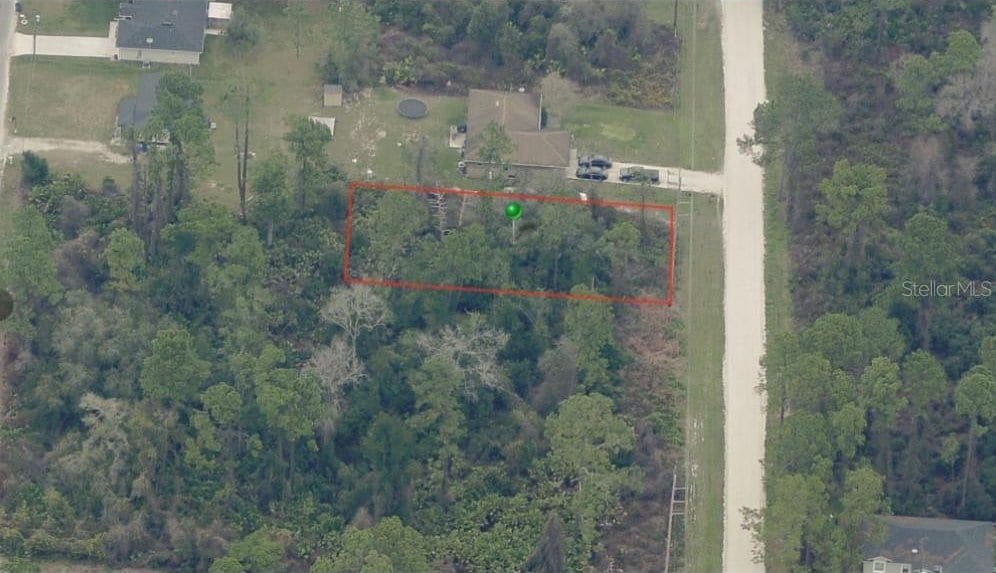 view of property location with property boundaries highlighted and a heavily wooded area