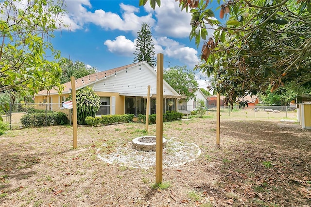 906 Elm Forest Dr, Minneola, FL 34715 - rear view of property with a fenced backyard and an outdoor fire pit