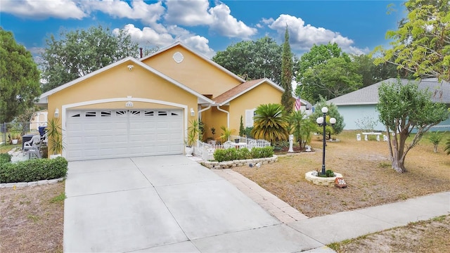 906 Elm Forest Dr, Minneola, FL 34715 - ranch-style home with stucco siding, an attached garage, concrete driveway, and fence