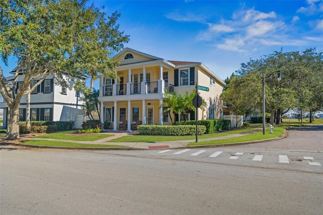 7550 Gathering Dr, Reunion, FL 34747 - neoclassical home featuring a balcony and stucco siding