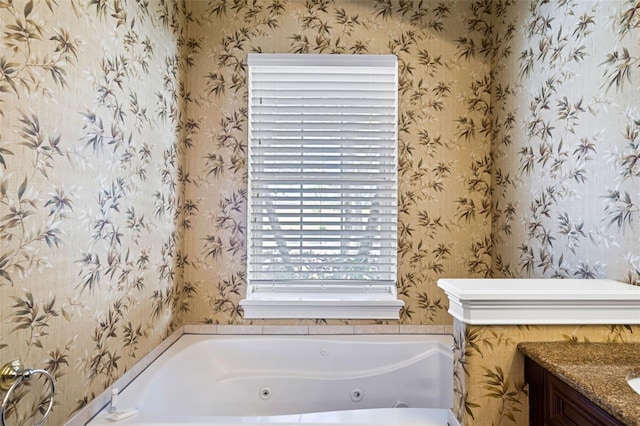 7550 Gathering Dr, Reunion, FL 34747 - full bath with wallpapered walls, a tub with jets, and vanity