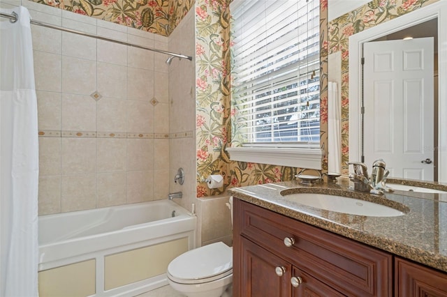 7550 Gathering Dr, Reunion, FL 34747 - bathroom featuring wallpapered walls, vanity, shower / tub combo with curtain, and toilet