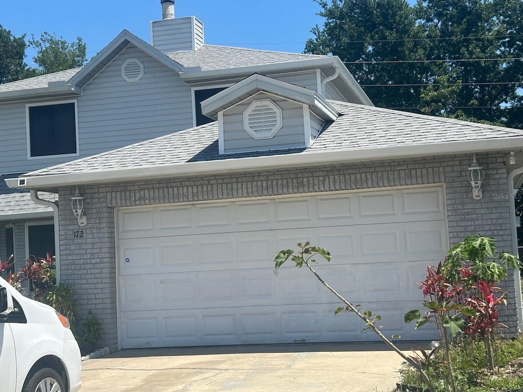 172 Pinewood Cir, Kissimmee, FL 34743 - garage with driveway