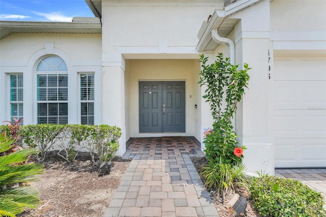 4796 Cumbrian Lakes Dr, Kissimmee, FL 34746 - entrance to property with a garage and stucco siding