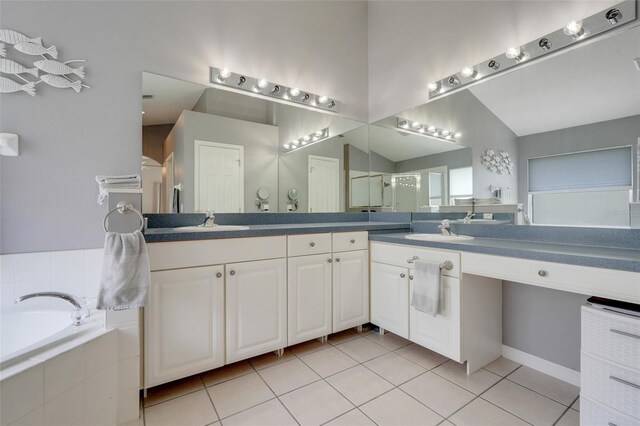4796 Cumbrian Lakes Dr, Kissimmee, FL 34746 - full bathroom with double vanity, a bath, tile patterned flooring, a shower with door, and vaulted ceiling