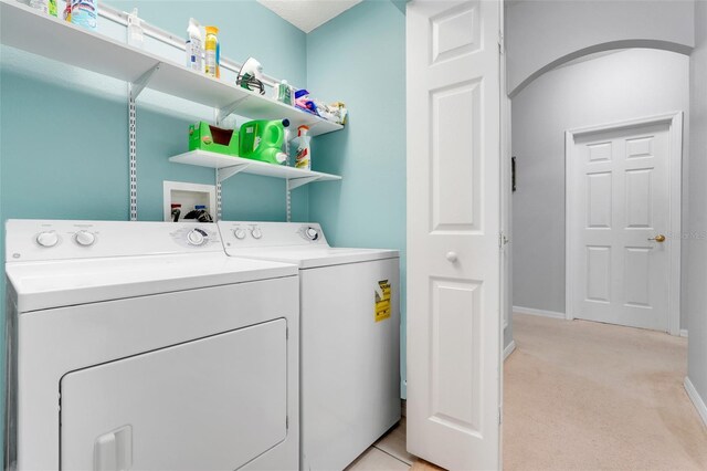 4796 Cumbrian Lakes Dr, Kissimmee, FL 34746 - washroom featuring separate washer and dryer, light carpet, and baseboards