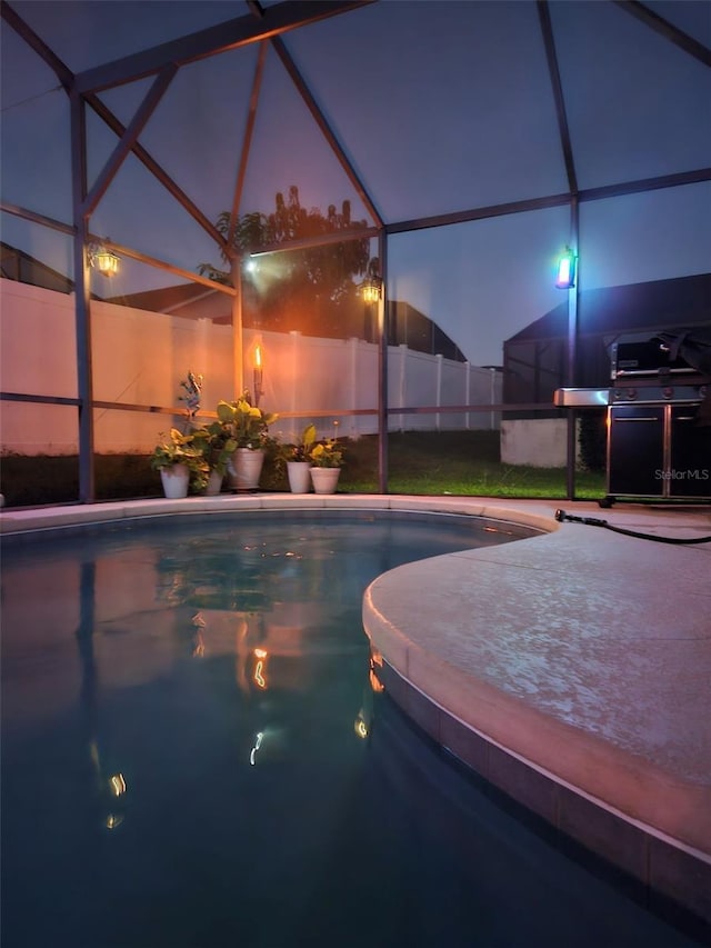 4796 Cumbrian Lakes Dr, Kissimmee, FL 34746 - pool at twilight with a jacuzzi, glass enclosure, and a grill