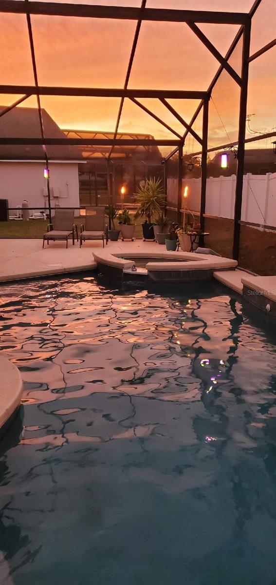 4796 Cumbrian Lakes Dr, Kissimmee, FL 34746 - pool at dusk featuring a lanai, a pool, and a patio
