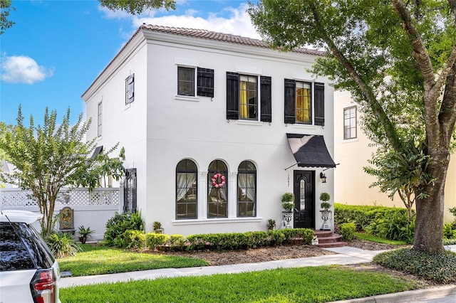 1047 Banks Rose St, Kissimmee, FL 34747 - mediterranean / spanish-style home with stucco siding, fence, and a tiled roof