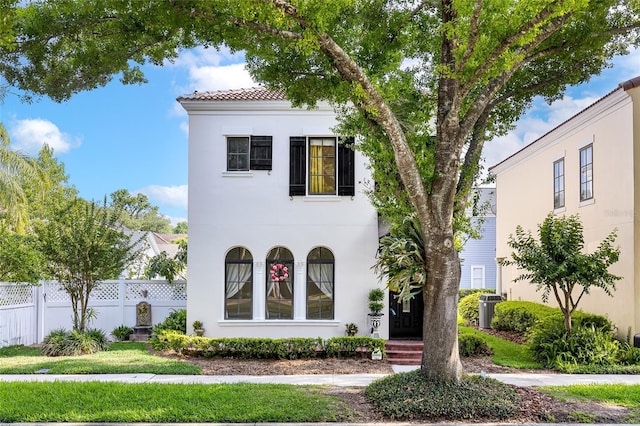 1047 Banks Rose St, Kissimmee, FL 34747 - mediterranean / spanish home with fence, stucco siding, central AC, and a tiled roof
