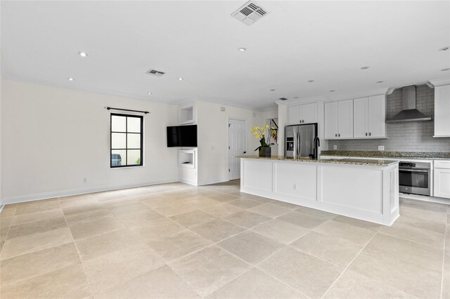 1047 Banks Rose St, Kissimmee, FL 34747 - kitchen with wall chimney exhaust hood, stainless steel appliances, white cabinetry, tasteful backsplash, and recessed lighting