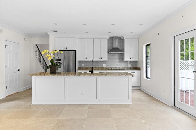 1047 Banks Rose St, Kissimmee, FL 34747 - kitchen with stainless steel refrigerator with ice dispenser, wall chimney range hood, tasteful backsplash, a kitchen island with sink, and white cabinets