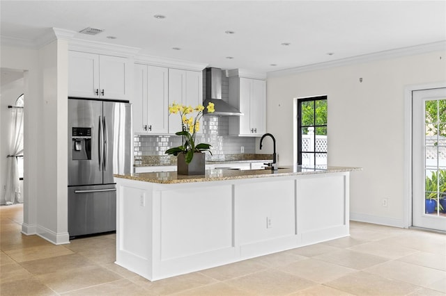 1047 Banks Rose St, Kissimmee, FL 34747 - kitchen featuring stainless steel fridge, wall chimney range hood, backsplash, plenty of natural light, and ornamental molding